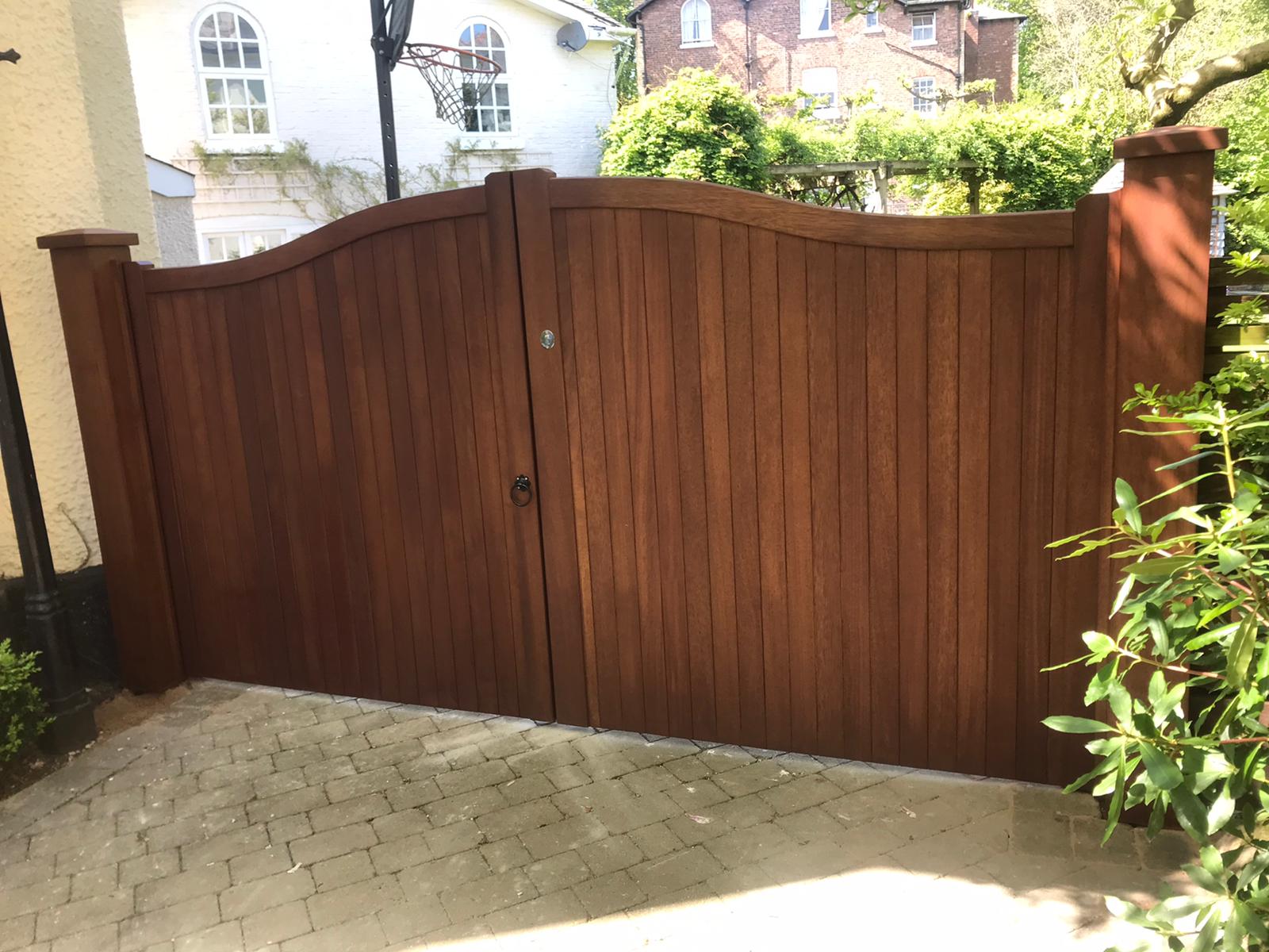 An Iroko hardwood double gate with a Swan Neck design