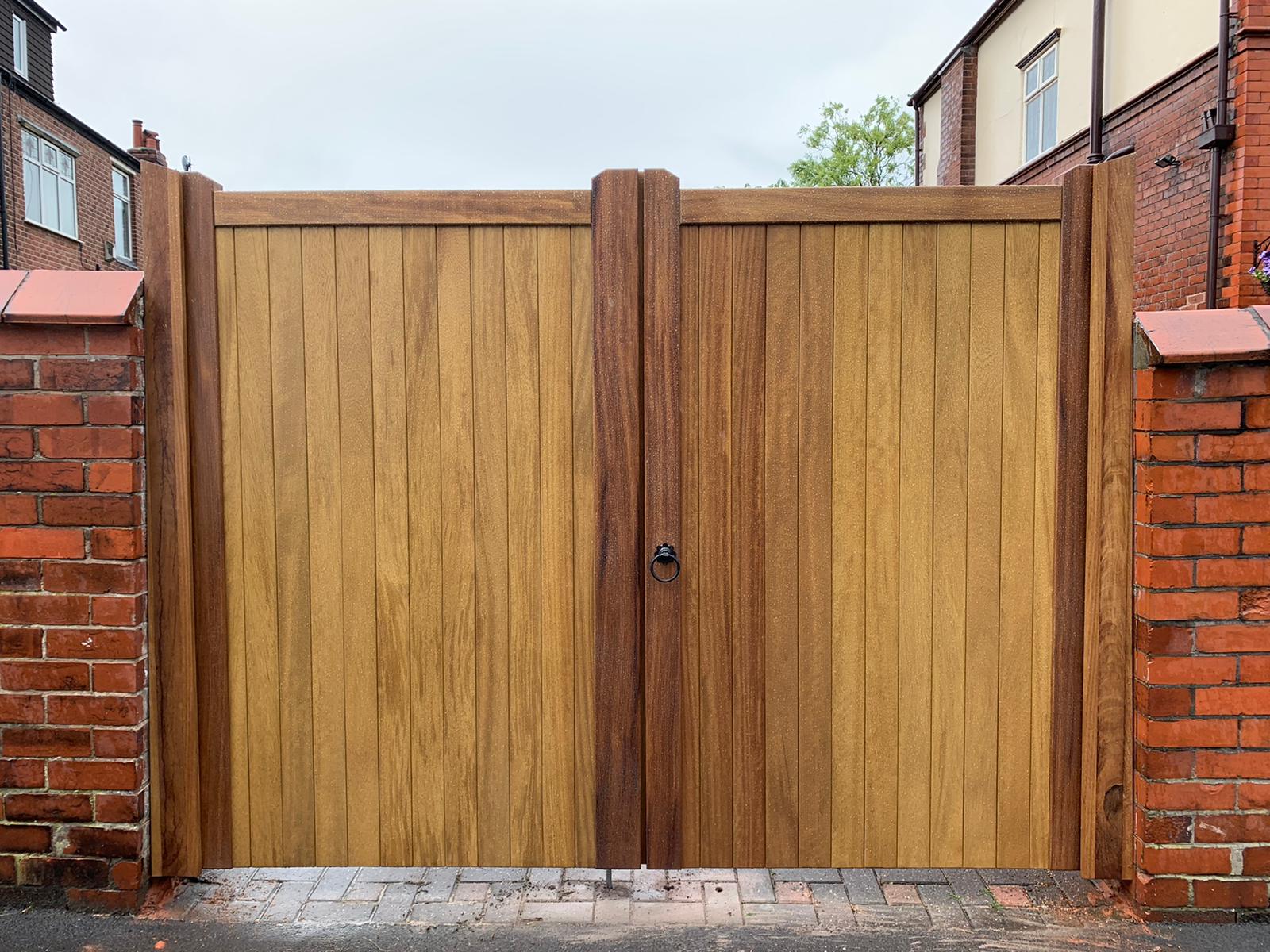 An Iroko wooden double gate in a Village design