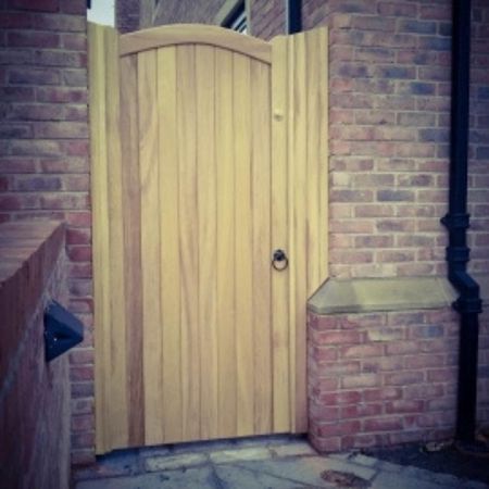 light wooden garden gate with a curved top