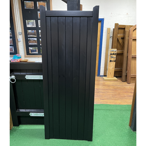 A single black softwood gate in a village design