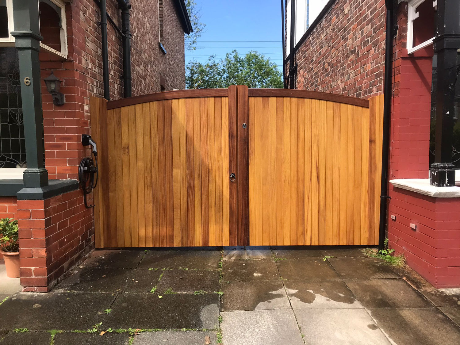 A hardwood sheer oil double gate with a curved top