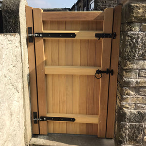 An Iroko hardwood single gate in a village design