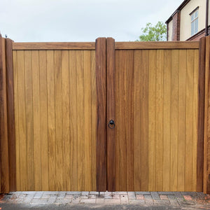 An Iroko wooden double gate in a Village design