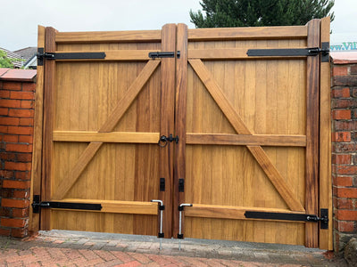 The back of an Iroko wooden double gate in a Village design